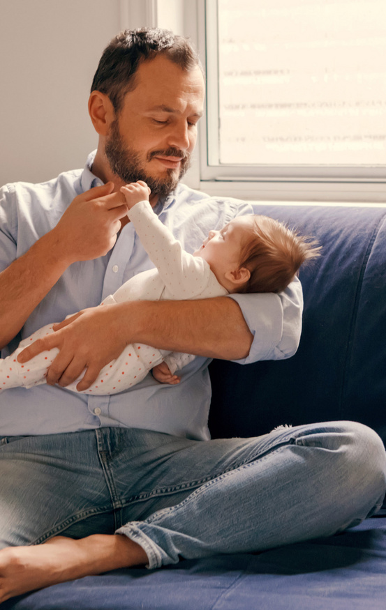 baby holding dads finger 